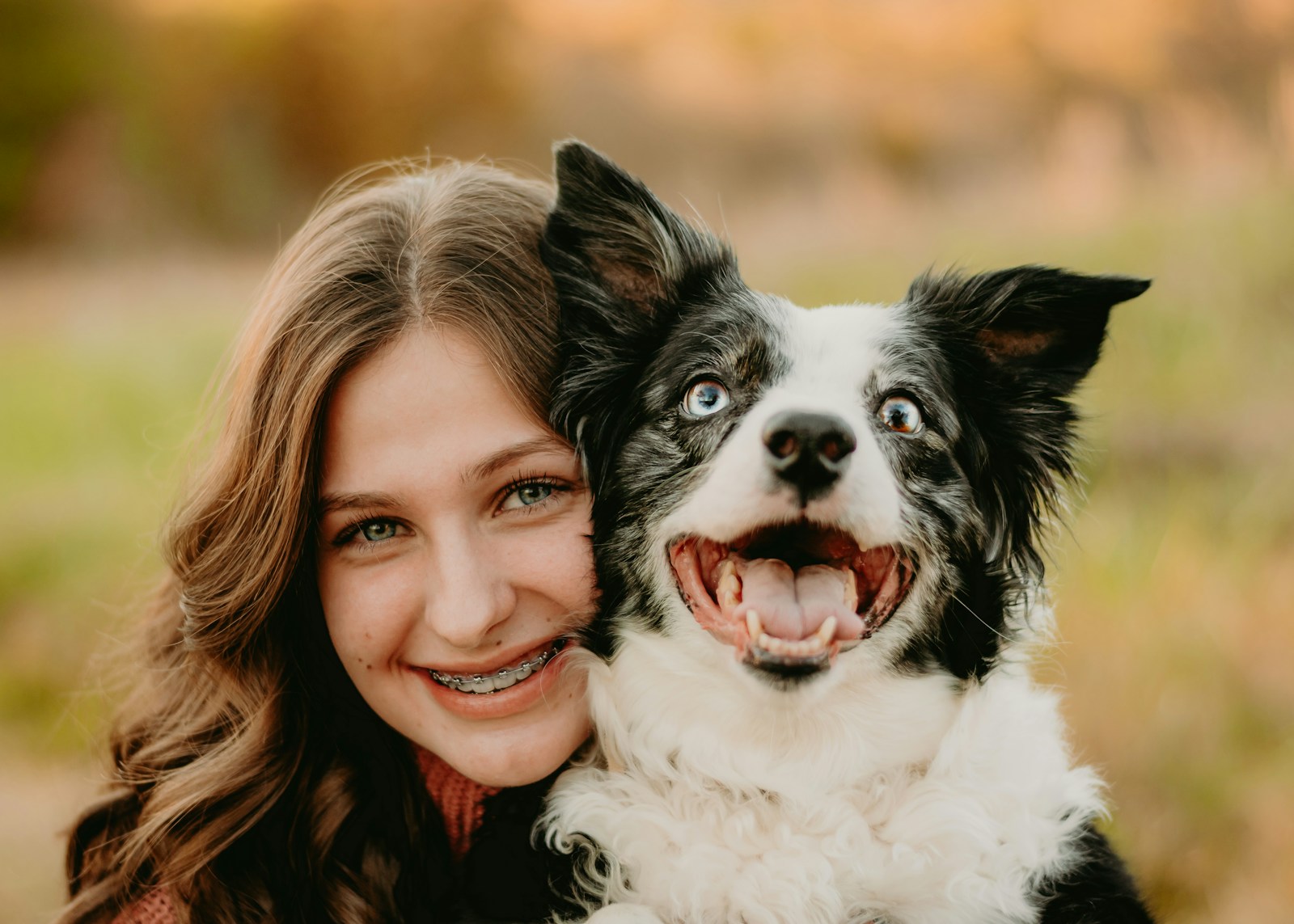Photo by Bailey Burton a woman is hugging a dog in a field